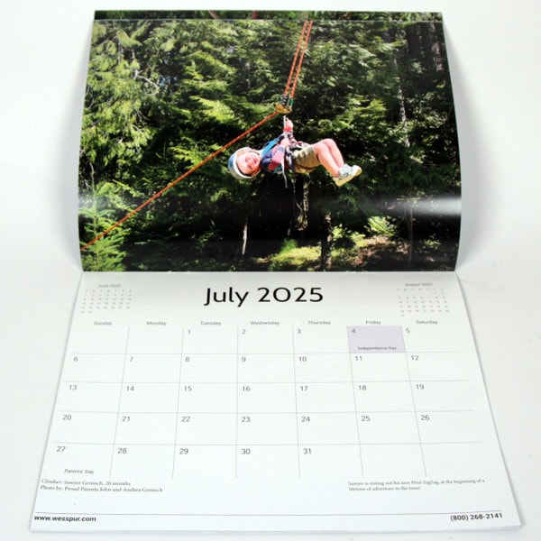 wesspur july calendar image shows a young child enjoying tree climbing with safety gear